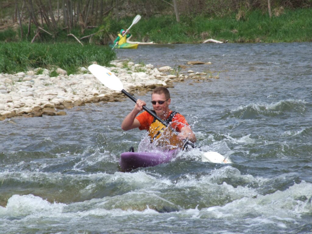 paddling hard in whitewater