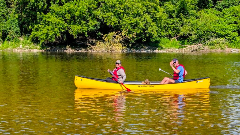 Couple in a yellow canoe paddling the heritage run to bingemans in kitchener