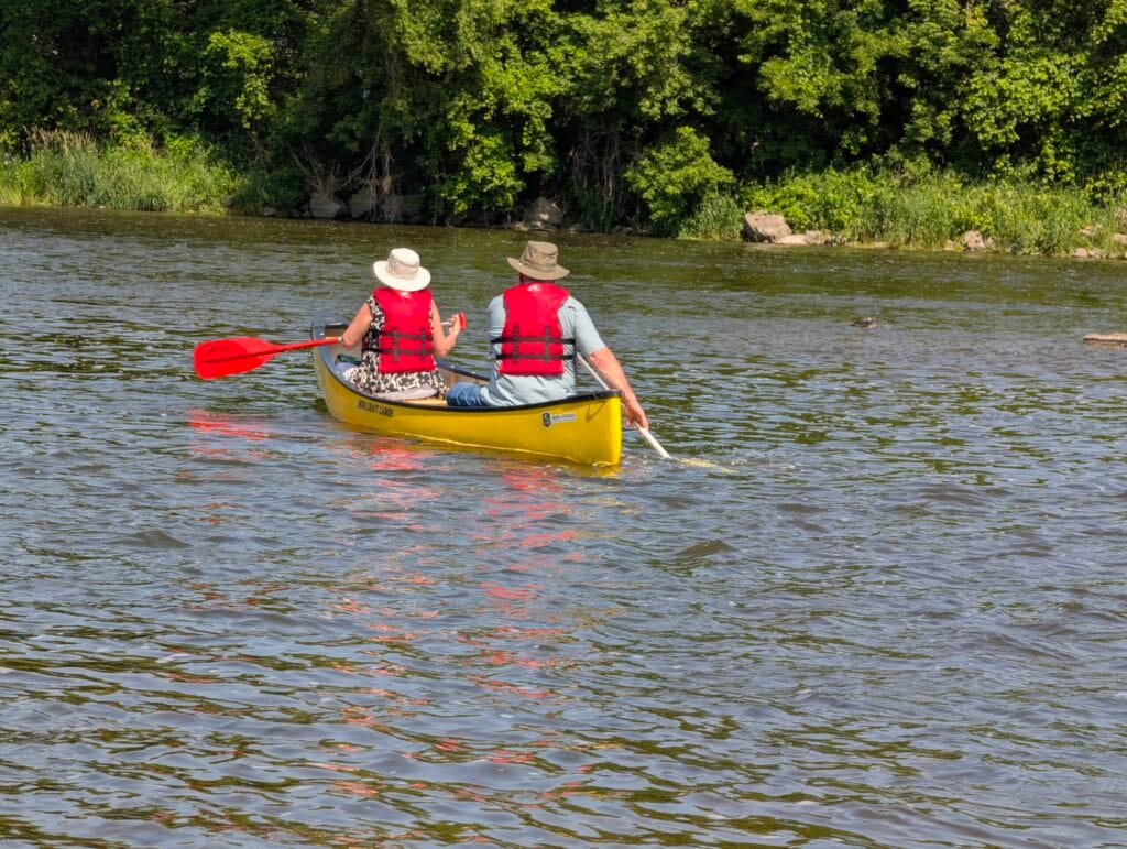 Older couple enjoying a canoe trip on the grand river