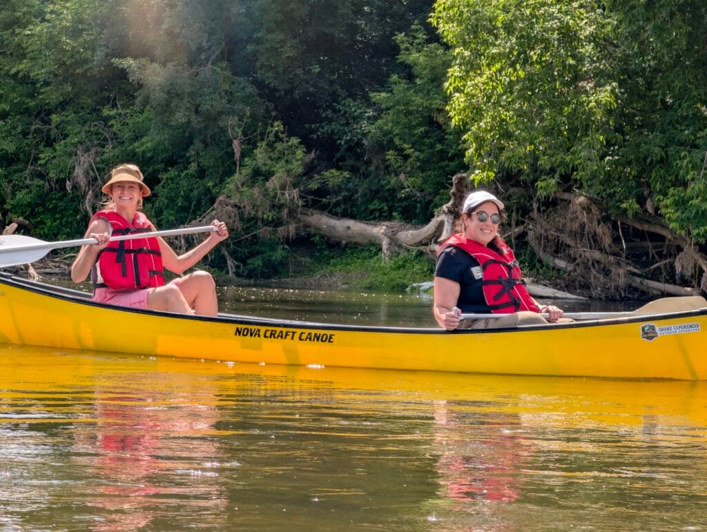 Two ladies paddling a canoe from kaufmans to bingemans